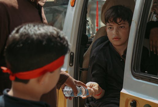 a teenager using a reusable water bottle